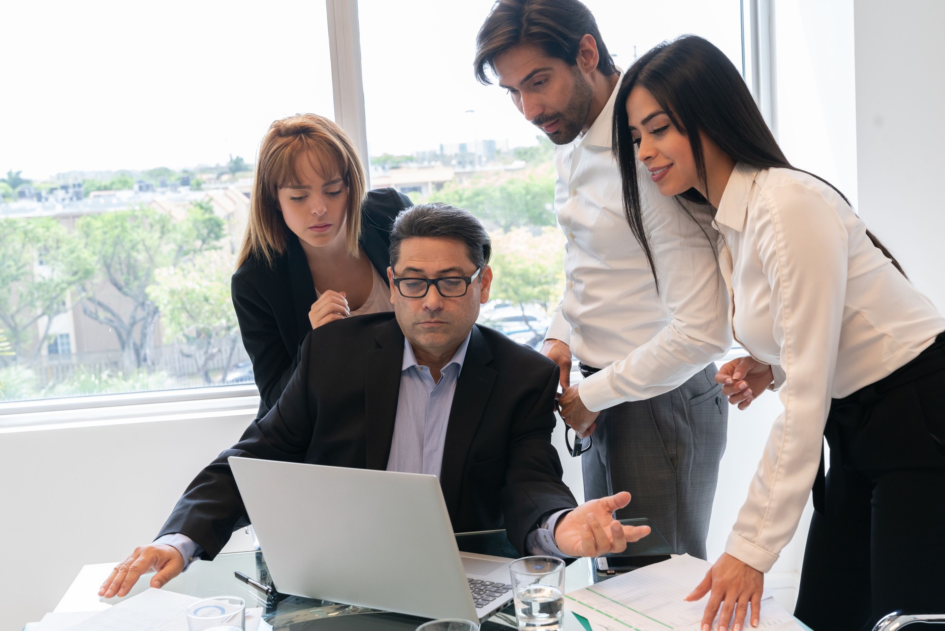 Latin group of colleagues working in computer in office
